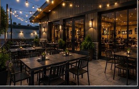 The covered patio under warm string lights, set with dark timber tables.